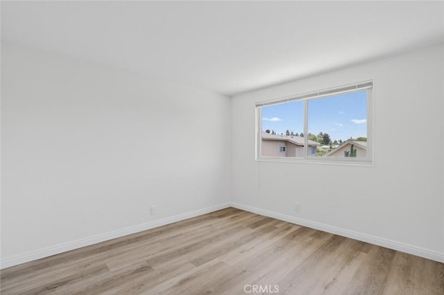 14652 Devonshire Ave, Tustin, CA 92780 - empty room with light wood-style floors and baseboards