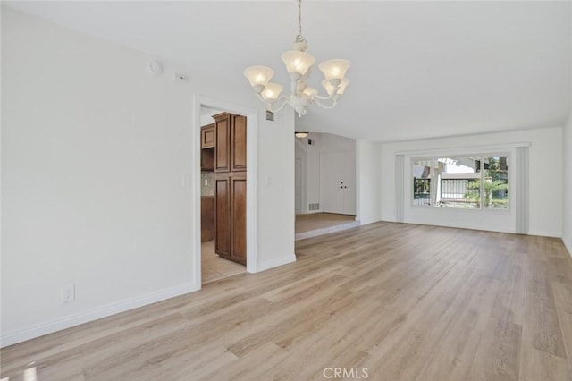 14652 Devonshire Ave, Tustin, CA 92780 - unfurnished living room featuring a chandelier and light wood-style floors