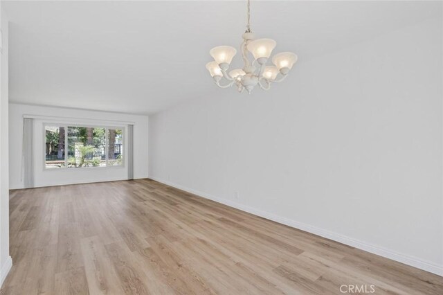 14652 Devonshire Ave, Tustin, CA 92780 - spare room with a chandelier and light wood-type flooring