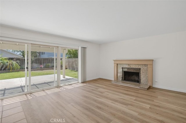 14652 Devonshire Ave, Tustin, CA 92780 - unfurnished living room featuring wood finished floors and a high end fireplace