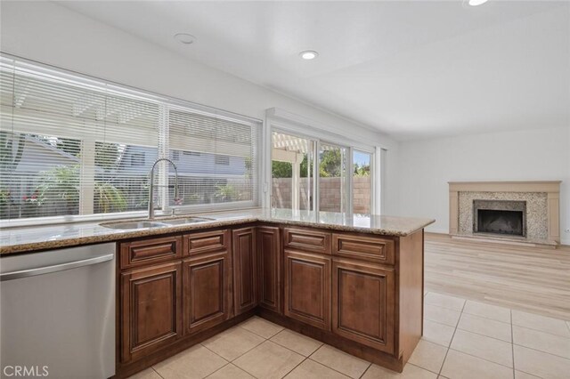 14652 Devonshire Ave, Tustin, CA 92780 - kitchen with stainless steel dishwasher, light tile patterned floors, light stone counters, a peninsula, and recessed lighting