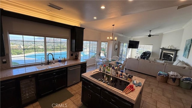 40107 Calle Breve, Temecula, CA 92592 - kitchen with stainless steel dishwasher, crown molding, black electric stovetop, vaulted ceiling, and a chandelier