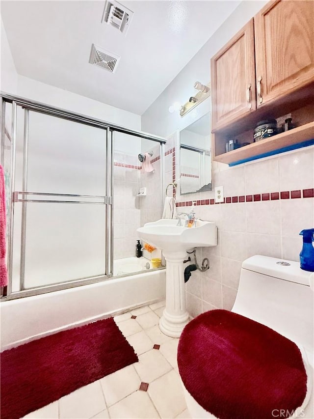 11425 Hayford St, Norwalk, CA 90650 - full bathroom featuring combined bath / shower with glass door, tile patterned floors, and tile walls