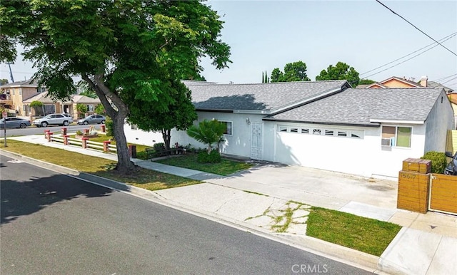 11425 Hayford St, Norwalk, CA 90650 - ranch-style house featuring a shingled roof, an attached garage, driveway, and stucco siding