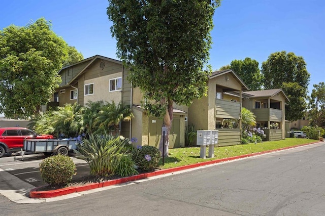 190 Avenida Descanso Unit I, Oceanside, CA 92057 - view of front facade featuring uncovered parking and stucco siding