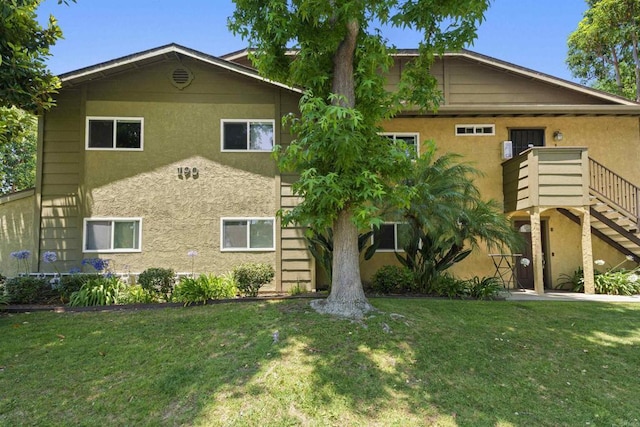 190 Avenida Descanso Unit I, Oceanside, CA 92057 - view of front of house featuring stucco siding, a front lawn, and stairs