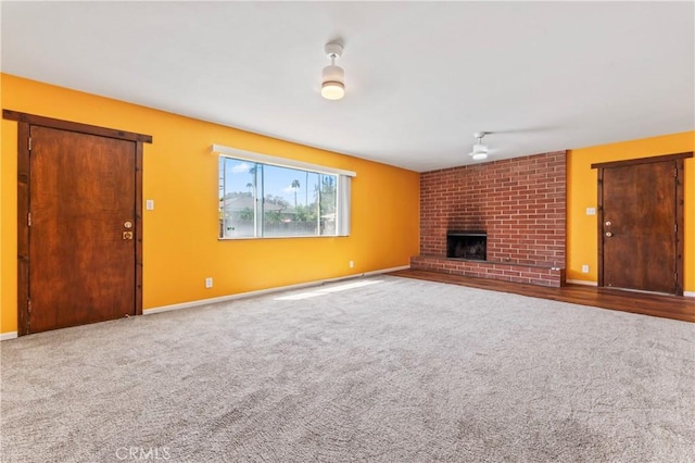 4136 Eileen St, Riverside, CA 92504 - unfurnished living room featuring a brick fireplace, carpet floors, and a ceiling fan