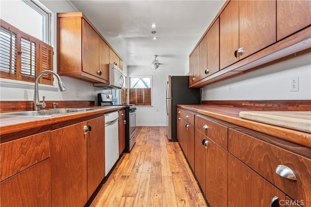 4136 Eileen St, Riverside, CA 92504 - kitchen with white appliances, ceiling fan, light wood-style flooring, brown cabinets, and butcher block countertops