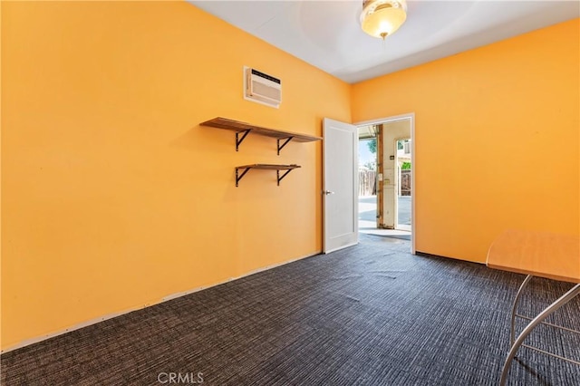 4136 Eileen St, Riverside, CA 92504 - empty room featuring a wall mounted AC and dark colored carpet