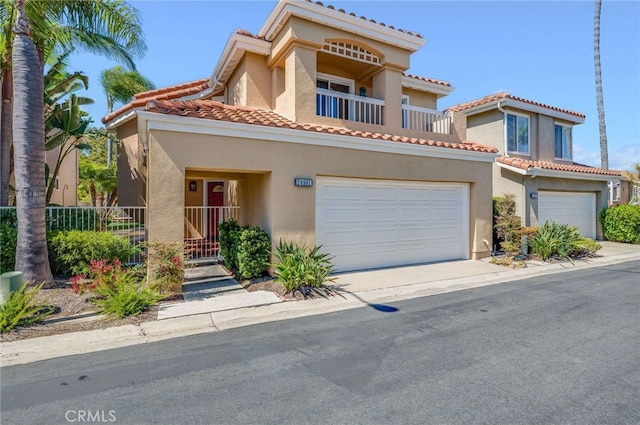 24961 Beachwalk Way, Dana Point, CA 92629 - view of front of home featuring stucco siding, a garage, a tile roof, and a balcony