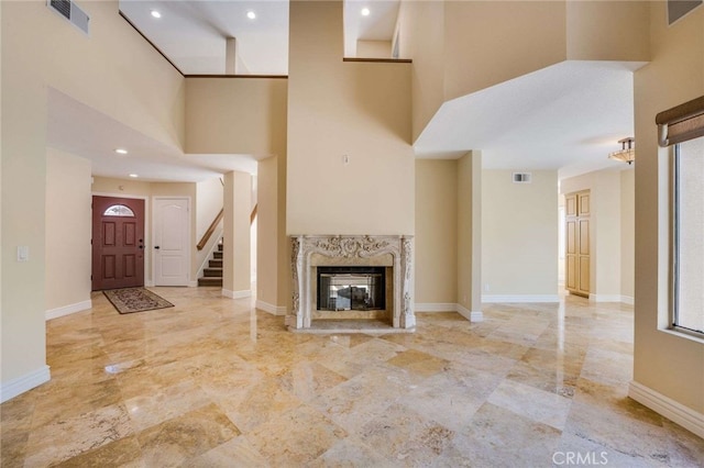 24961 Beachwalk Way, Dana Point, CA 92629 - unfurnished living room with a high ceiling, a high end fireplace, recessed lighting, and stairs