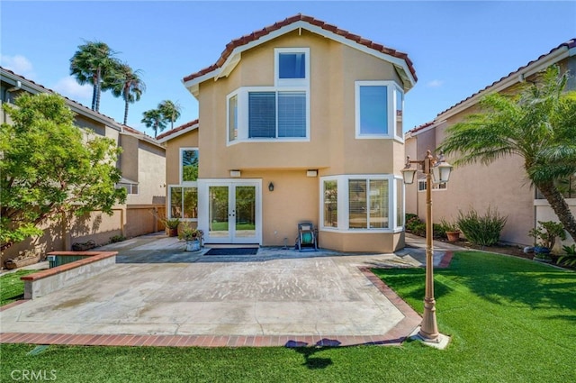24961 Beachwalk Way, Dana Point, CA 92629 - rear view of house with french doors, stucco siding, a patio, and a tiled roof
