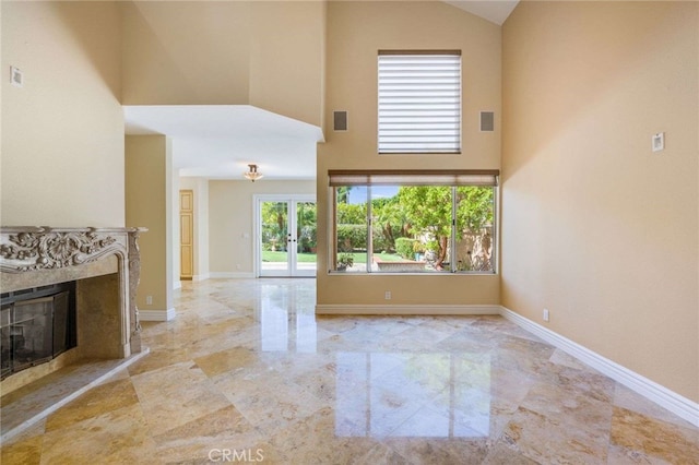 24961 Beachwalk Way, Dana Point, CA 92629 - unfurnished living room featuring high vaulted ceiling, marble tiled floors, and a high end fireplace