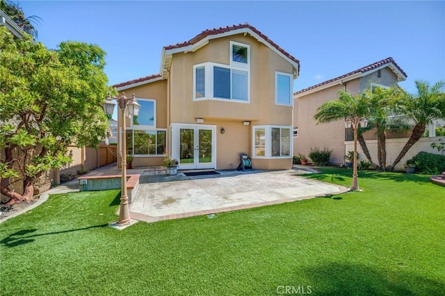 24961 Beachwalk Way, Dana Point, CA 92629 - rear view of house with french doors, stucco siding, a fenced backyard, a tiled roof, and a patio area