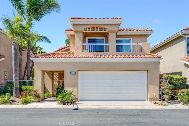 24961 Beachwalk Way, Dana Point, CA 92629 - mediterranean / spanish house with an attached garage, stucco siding, a tile roof, and concrete driveway