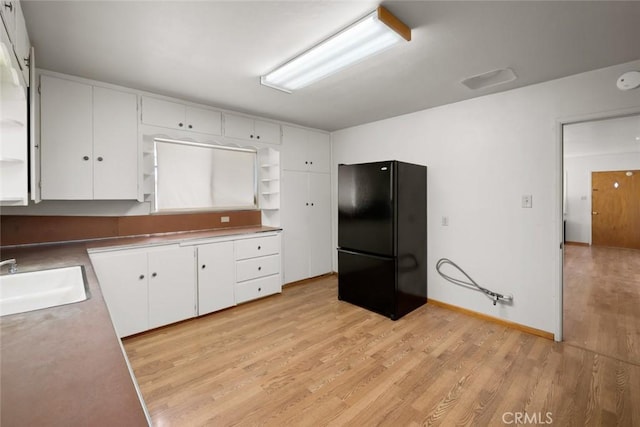 1756 6th St, Los Osos, CA 93402 - kitchen featuring freestanding refrigerator, open shelves, and white cabinets