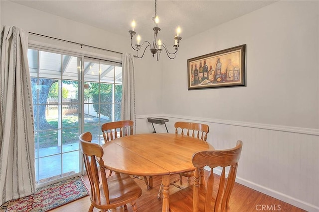 1242 2nd Pl, Calimesa, CA 92320 - dining room with light wood-style floors, a chandelier, and wainscoting