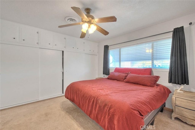1242 2nd Pl, Calimesa, CA 92320 - bedroom with light carpet, ceiling fan, and a closet