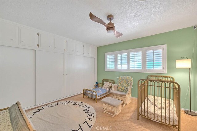 1242 2nd Pl, Calimesa, CA 92320 - carpeted bedroom with a textured ceiling, ceiling fan, and a closet