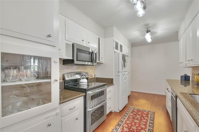 1242 2nd Pl, Calimesa, CA 92320 - kitchen featuring stainless steel appliances, light wood finished floors, white cabinets, and decorative backsplash