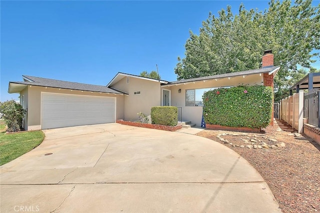 1242 2nd Pl, Calimesa, CA 92320 - view of front of property with stucco siding, concrete driveway, a chimney, and a garage