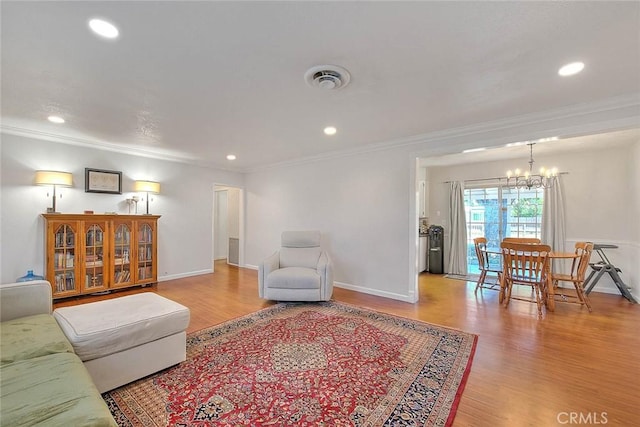 1242 2nd Pl, Calimesa, CA 92320 - living room with a chandelier, light wood-type flooring, crown molding, and recessed lighting