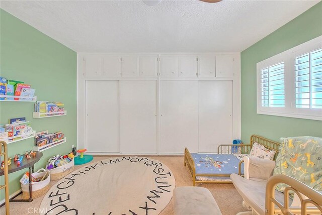 1242 2nd Pl, Calimesa, CA 92320 - bedroom featuring a textured ceiling, light carpet, and a closet