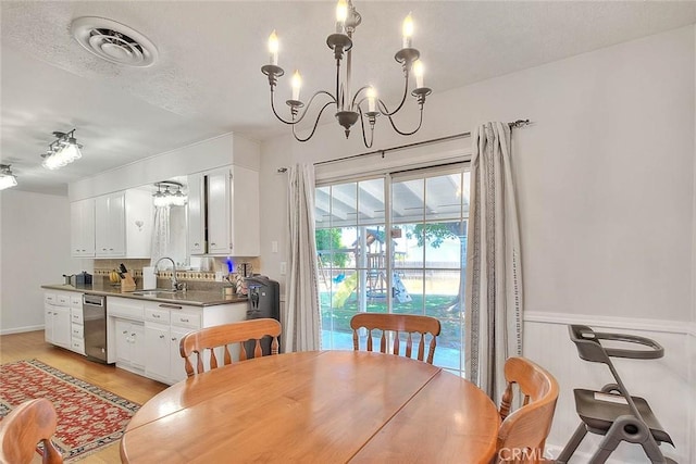 1242 2nd Pl, Calimesa, CA 92320 - dining space with a chandelier, a textured ceiling, and light wood-style flooring