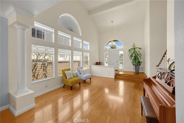 4350 Bennington Ct, Chino, CA 91710 - living area with decorative columns, light wood finished floors, high vaulted ceiling, beam ceiling, and stairs