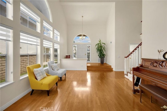 4350 Bennington Ct, Chino, CA 91710 - entrance foyer with a high ceiling, wood finished floors, a chandelier, and stairs
