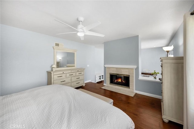 4350 Bennington Ct, Chino, CA 91710 - bedroom featuring a tile fireplace, dark wood-style flooring, and a ceiling fan