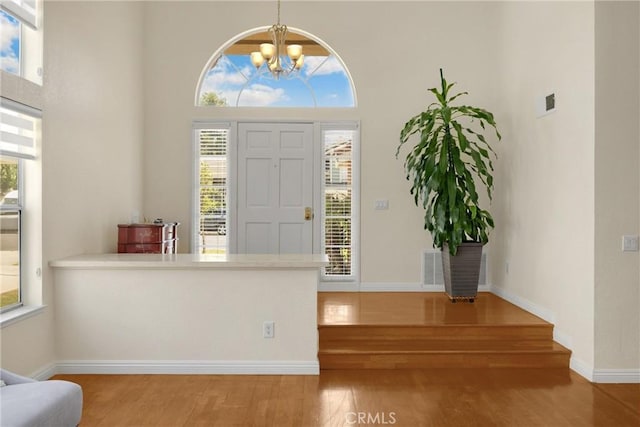 4350 Bennington Ct, Chino, CA 91710 - entrance foyer featuring a high ceiling, wood finished floors, a chandelier, and healthy amount of natural light