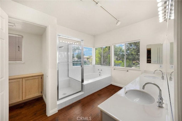 4350 Bennington Ct, Chino, CA 91710 - bathroom with wood finished floors, double vanity, a shower stall, a garden tub, and track lighting
