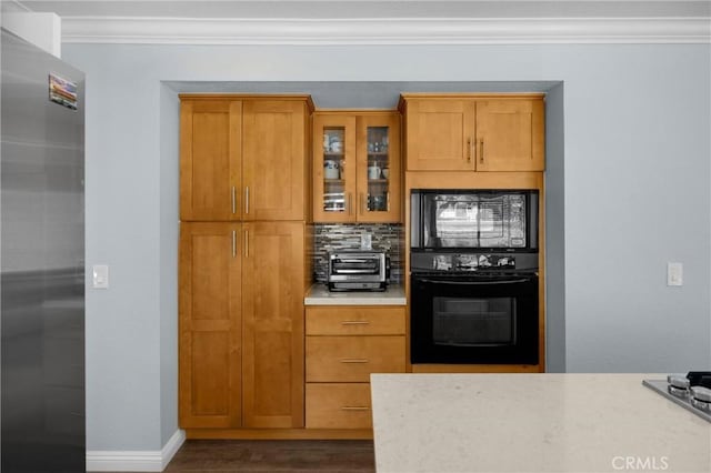4350 Bennington Ct, Chino, CA 91710 - kitchen with black appliances, crown molding, wood finished floors, tasteful backsplash, and glass insert cabinets