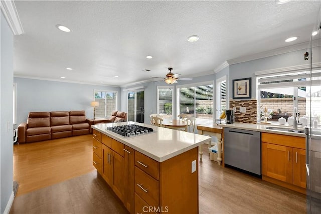 4350 Bennington Ct, Chino, CA 91710 - kitchen with appliances with stainless steel finishes, light wood-type flooring, a center island, recessed lighting, and a ceiling fan
