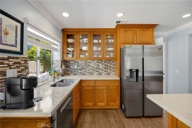 4350 Bennington Ct, Chino, CA 91710 - kitchen featuring appliances with stainless steel finishes, brown cabinetry, ornamental molding, wood finished floors, and recessed lighting