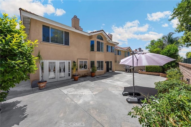4350 Bennington Ct, Chino, CA 91710 - back of house with french doors, a chimney, stucco siding, and a patio area