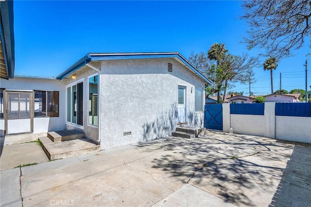 835 E 222nd St, Carson, CA 90745 - view of home's exterior featuring a patio, a gate, and stucco siding
