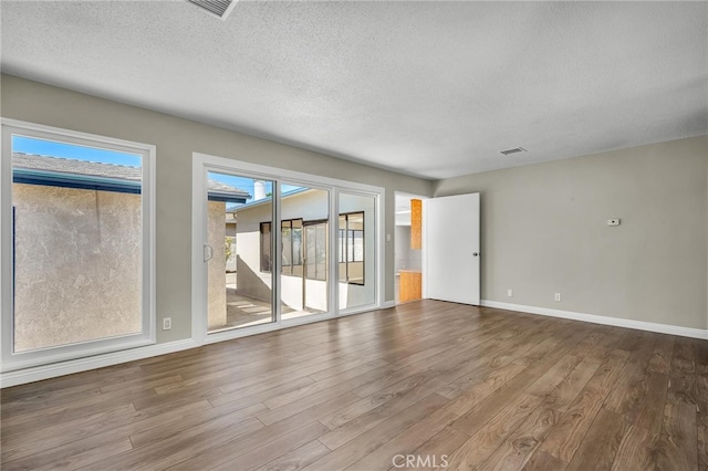 835 E 222nd St, Carson, CA 90745 - empty room with wood finished floors and a textured ceiling