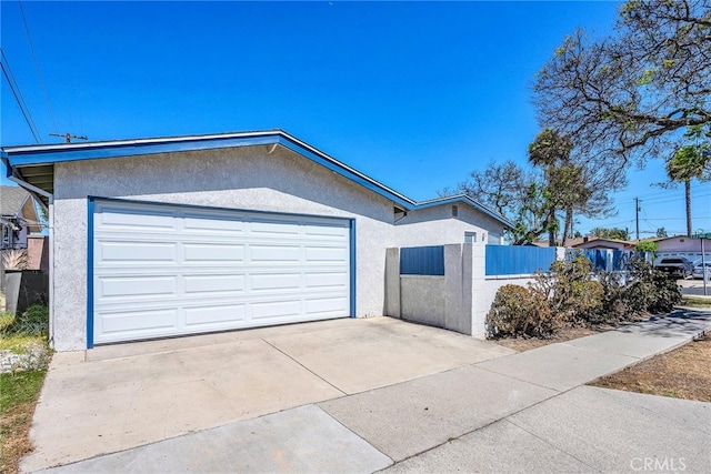 835 E 222nd St, Carson, CA 90745 - view of front facade featuring stucco siding, concrete driveway, and an attached garage