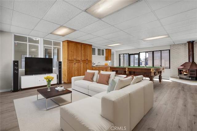835 E 222nd St, Carson, CA 90745 - living area featuring billiards table, a wood stove, light wood finished floors, and a drop ceiling