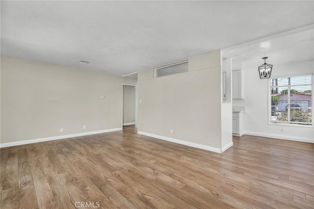 835 E 222nd St, Carson, CA 90745 - unfurnished room featuring light wood finished floors and a chandelier