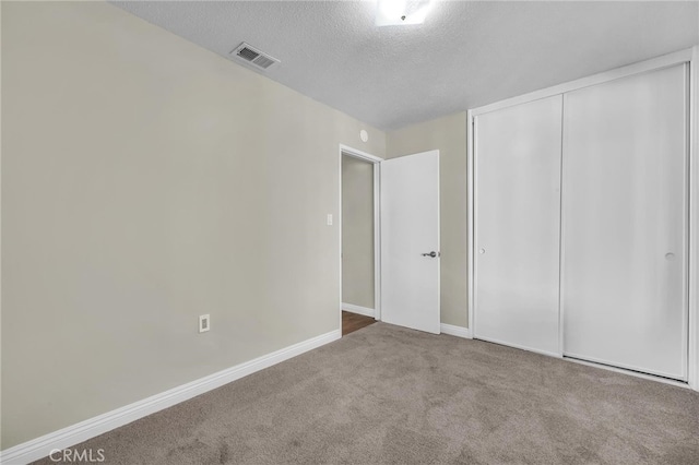 835 E 222nd St, Carson, CA 90745 - unfurnished bedroom with a textured ceiling, carpet flooring, and a closet