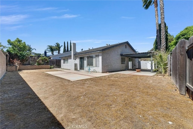1407 Opal St, Corona, CA 92882 - rear view of house featuring a patio area, a fenced backyard, and stucco siding