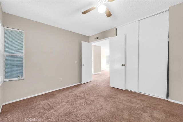 1407 Opal St, Corona, CA 92882 - unfurnished bedroom featuring carpet floors, a closet, a textured ceiling, and ceiling fan