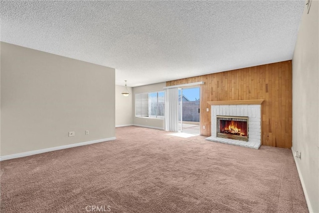 1407 Opal St, Corona, CA 92882 - unfurnished living room with carpet floors, a brick fireplace, wood walls, and a textured ceiling