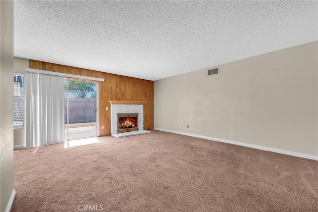 1407 Opal St, Corona, CA 92882 - unfurnished living room featuring carpet floors, wooden walls, a textured ceiling, and a brick fireplace