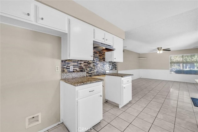 1407 Opal St, Corona, CA 92882 - kitchen featuring under cabinet range hood, ceiling fan, decorative backsplash, white cabinetry, and light tile patterned floors
