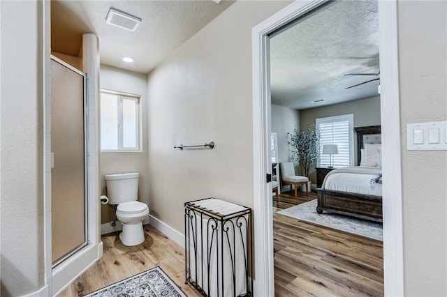 7434 Paisley Ave, Hesperia, CA 92345 - ensuite bathroom featuring a textured ceiling, wood finished floors, a shower stall, and ceiling fan