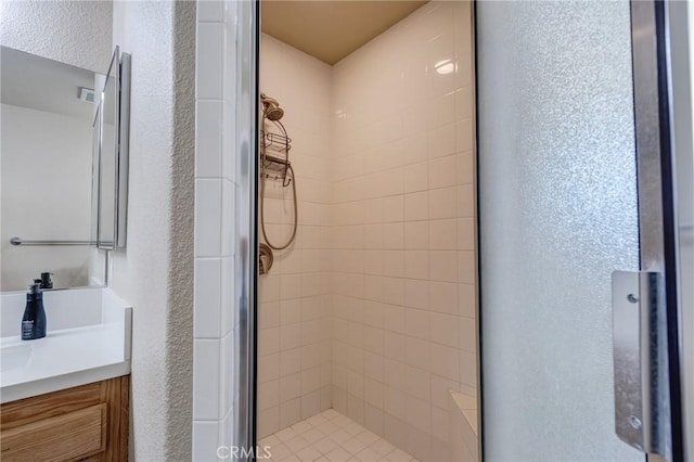 7434 Paisley Ave, Hesperia, CA 92345 - bathroom featuring a shower stall, vanity, and a textured wall